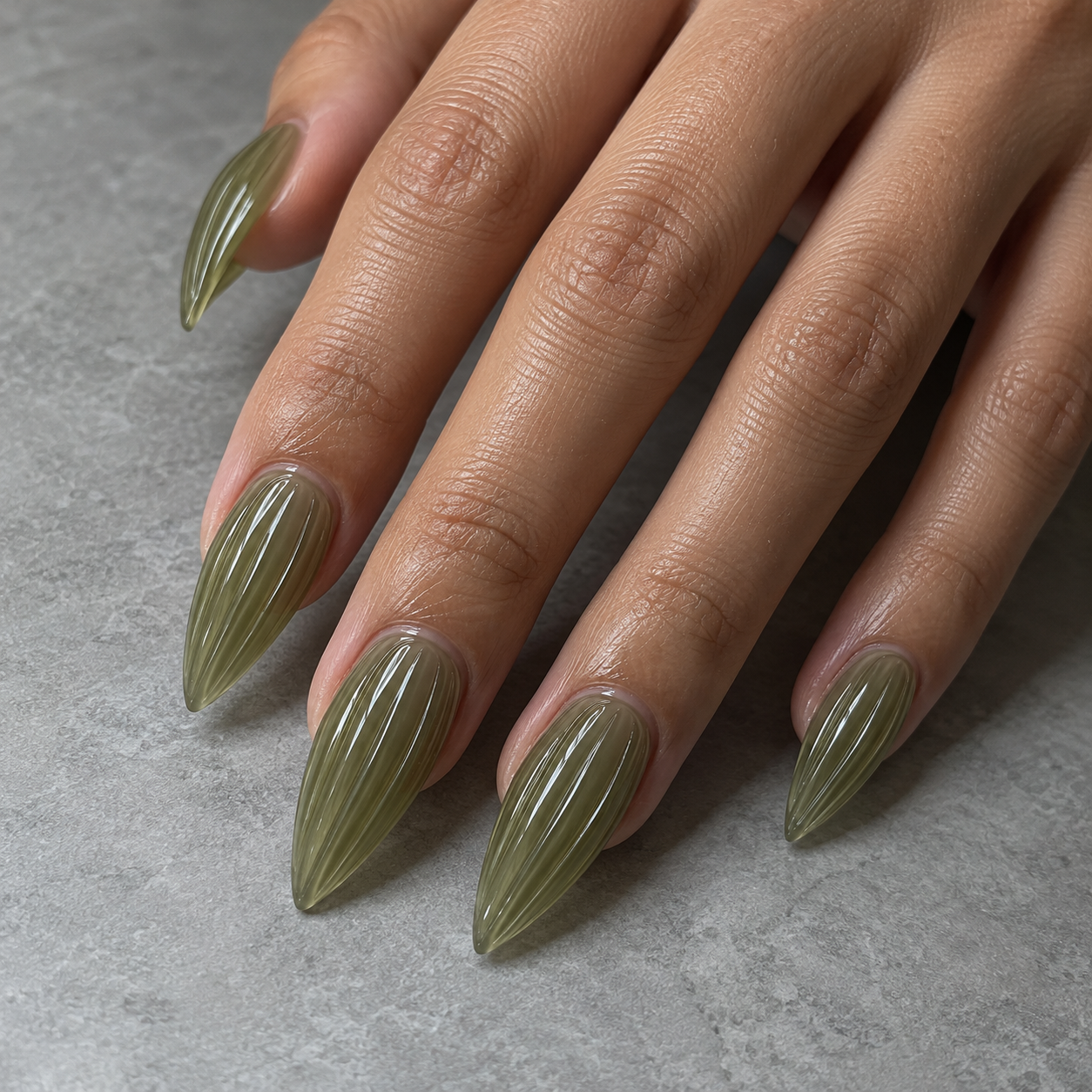 Muted olive stiletto soft-gel extensions with a fine ribbed-glass finish